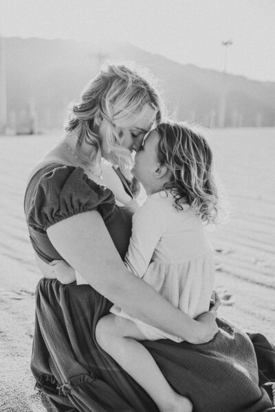 Mother and daughter touching noses during a family photoshoot in the Palm Springs area. 