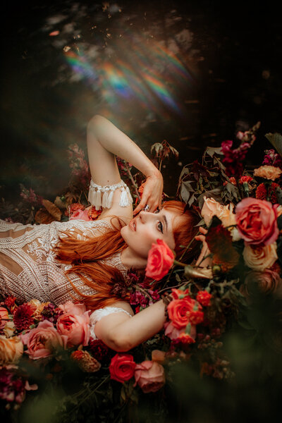 woman laying in roses