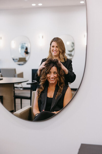 Happy client and stylist after hair appointment