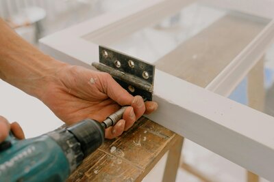 A skilled craftsman installing hardware, demonstrating the quality workmanship of Signature Renovating in Toledo, Ohio.