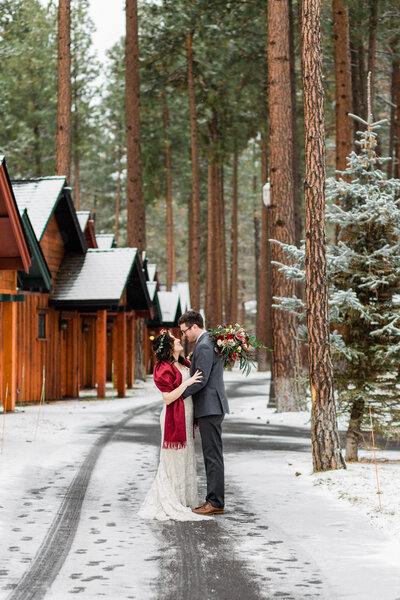 A groom in a green suit twirls his bride wearing a pink rue de Seine gown at their Oregon Coast elopement in Neskowin.