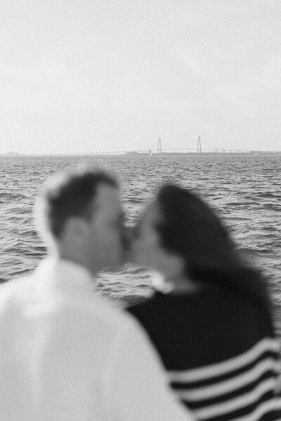 couple in charleston in front of venue kissins forehead