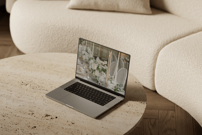 A laptop sitting on a stone table.