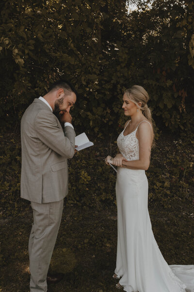 Groom reading vows to wife outside in West Salem, Wisconsin