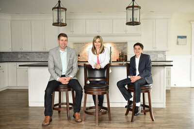 Family of real estate sitting in white bright kitchen investors