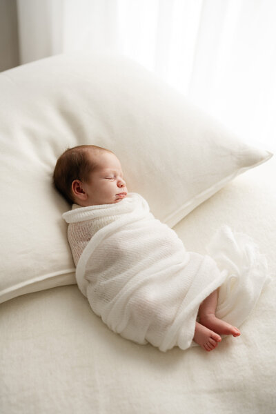 Newborn baby with arms stretched overhead during Sydney newborn session