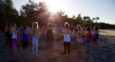 Students in group circle during Soma Yoga Institute’s Costa Rica yoga teacher training, fostering connection and community in a tropical setting