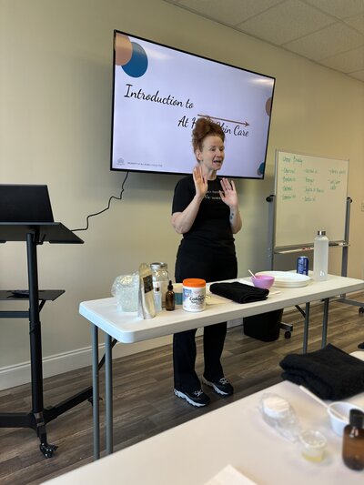 Jenny teaching massage therapists in a live CE course