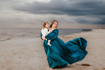 Mother and daughter hugging during maternity photoshoot