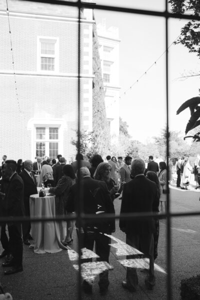 Black tie wedding at Kohl Mansion cocktail hour in between moments captured by a wedding photographer MVF Portraits 