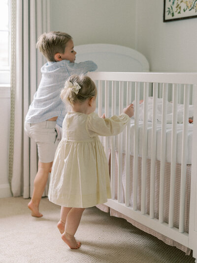 Children peeking over the crib