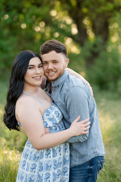 Couple smiling on in the golden hour light in Oak Grove Park in Ripon, California