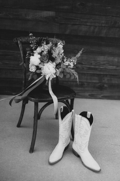 Boots next to chair with bouquet
