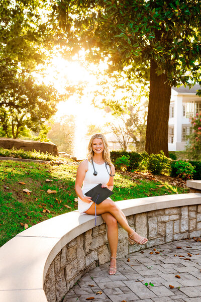 Trevecca ortho graduating senior at bell tower at golden hour
