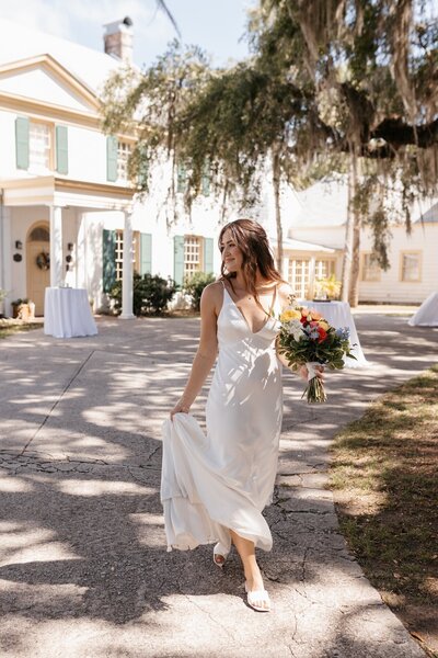 indie west portfolio image of bride dancing with bouquet on wedding day