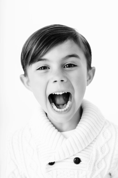 boy with big personality looking at camera with huge smile 