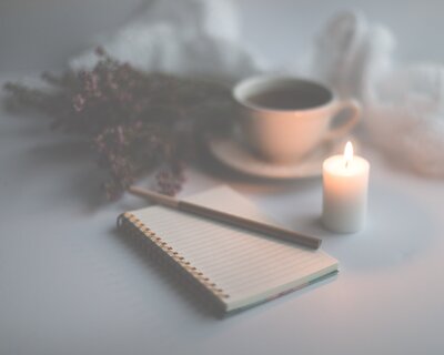 Soul Blossom relaxing moment with a candle, journal and a cuppa