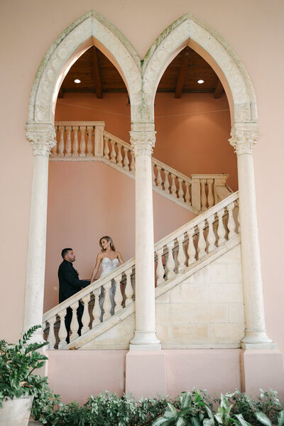 Bride and Groom as they walk up the stairs at the Boca Raton Resort in Boca Raton, Florida. Photo by Maggie Alvarez Photography