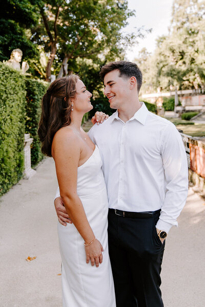 couple in garden smiling at each other