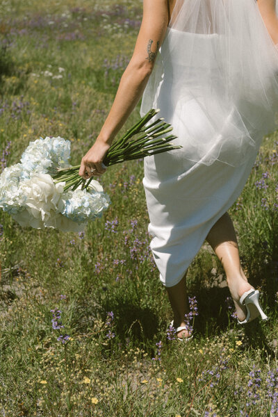 woman walking in the field with flowers