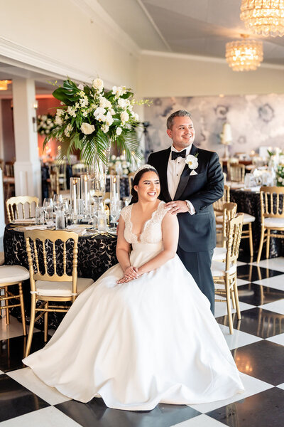 Bride and Groom standing on staircase with long dress at La Valencia wedding venue