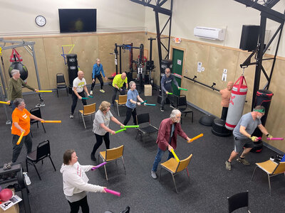 A group of Parkinson's warriors follow along during a Parkinson's exercise class in the Parkinson's warriors gym in Eugene.