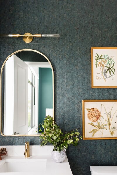 Inspiration for your powder bathroom. textured wallpaper, elegant gold fixtures and beautiful framed art pieces will elevate any space.