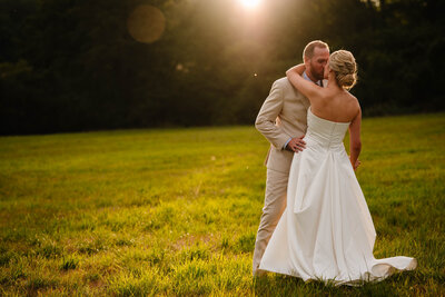 Bride and groom posing for portrait with white walls