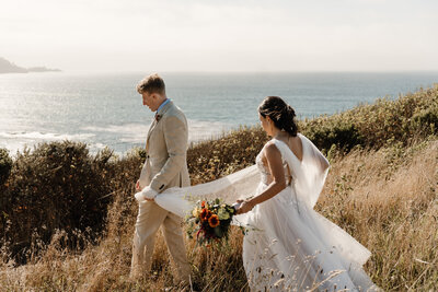 bride and groom walking along carmel coast during elopement