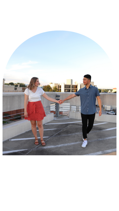 Engaged Couple holding hands on a rooftop downtown in Columbia South Carolina