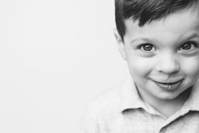 Side angle of happy boy looking at St. Petersburg photographer