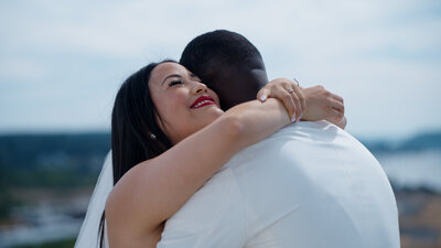 bride embracing groom while smiling
