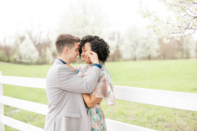 an engaged couple shares a romantic moment during a spring engagement sesssion