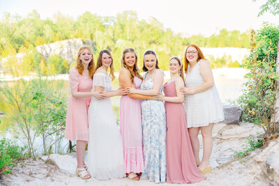 sorority girls laughing together in Klondike park with water and sand in the background