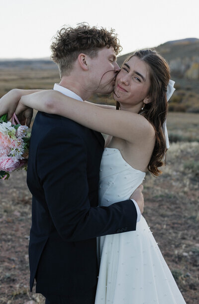 Bride and groom are posing for their portraits during their intimate elopement in northern Colorado. Captured by a Minnesota based wedding and elopement photographer.