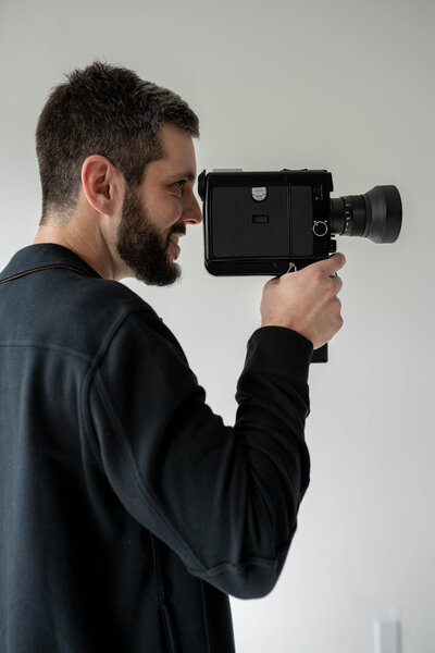 California Super 8 wedding videographer holding a super 8 camera.