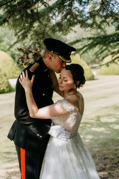 Bride and groom posing for portrait with white walls
