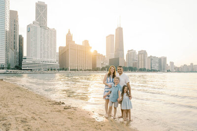 Family of four walking along Ohio St Beach in downtown Chicago by Chicago photographer Kristen Hazelton