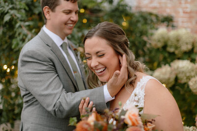 bride and groom laughing and joking around