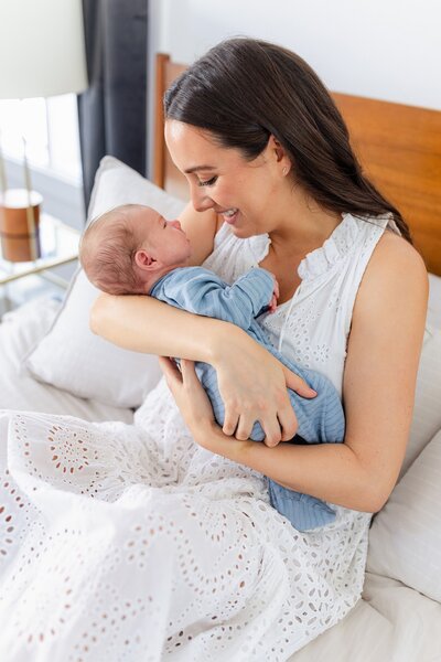 bright and airy photo of mom holding her newborn baby at her home in LA