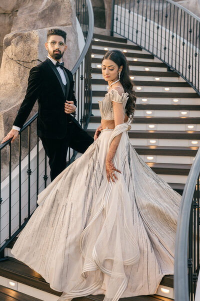 bride and groom posing on staircase