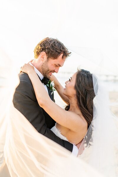 Bride and groom under veil at Scripps Forum in La Jolla, California.