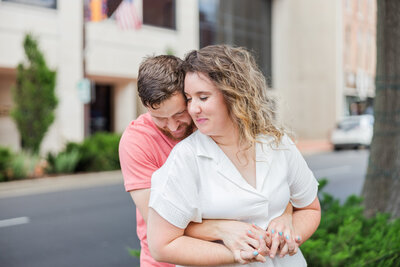 Engaged couple walking hand-in-hand on the family farm in Kentucky.