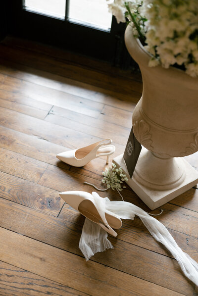 Close-up of handcrafted wedding shoes on stone steps at Charleston wedding venue Lowndes Grove