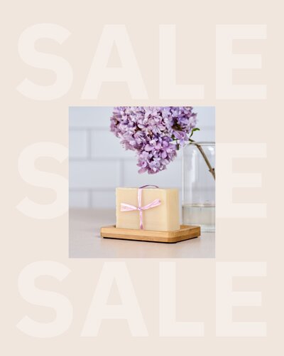 Spring Sales Sprint promotional image featuring a handmade soap bar wrapped with a pink ribbon, styled on a wood tray with lilac flowers in the background. Neutral aesthetic with “SALE” text overlay, designed to promote a spring sales planning course for product-based business owners looking to boost revenue with seasonal campaigns.