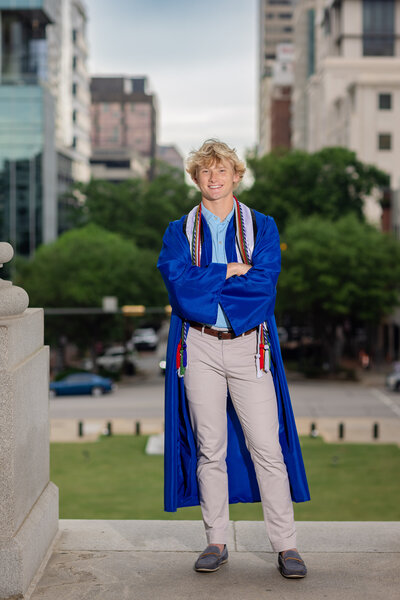 a boy standing at the state house in columbia, sc for his high school senior portraits