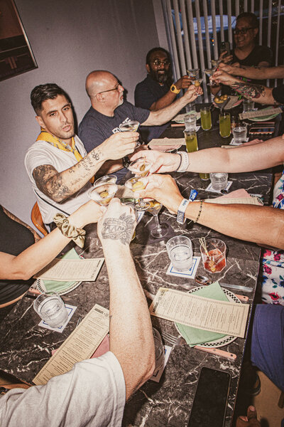 Performers posing by the pool at the Absolut Tales of the Cocktail 2023 event in New Orleans.