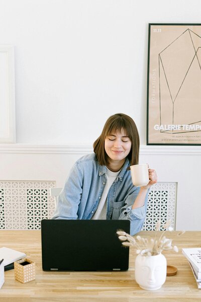Woman on her laptop with a cup of coffee. 