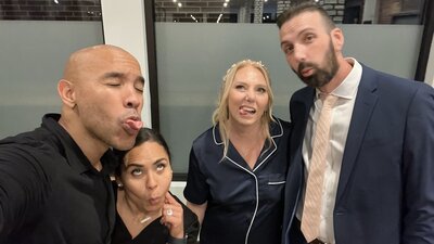 wedding videographer ariel poses for photo with minneapolis couple. groom has a beard