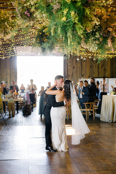 groom kissing bride on the dance floor